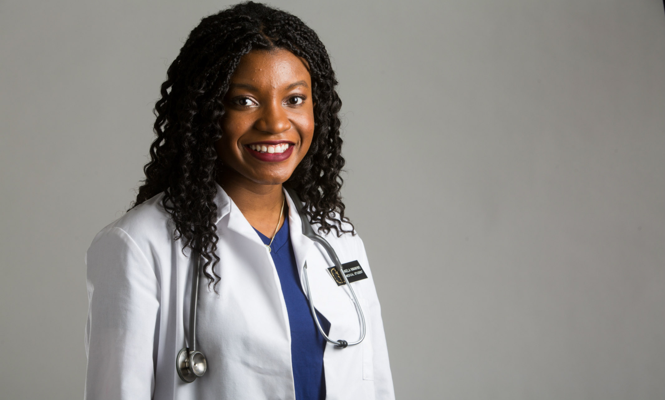Portrait of medical student Angela Nwankwo wearing a white coat